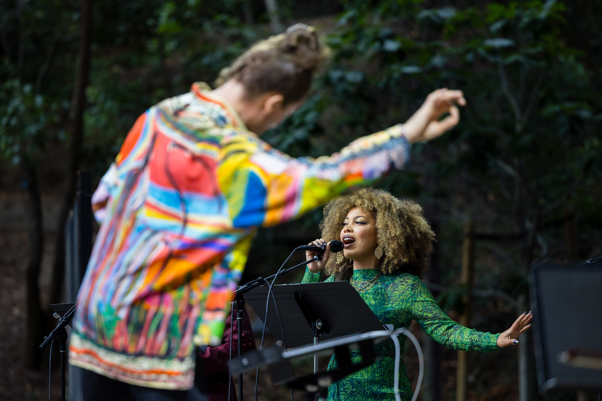 Conductor and vocalist India performing outdoors